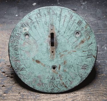 photo of a  sundial being restored