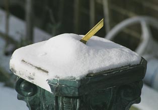 sundial covered with snow
